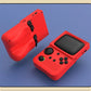 Red handheld gaming console with black screen and buttons on a blue surface